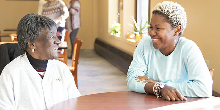 ​At Charlesgate Park West, a Providence senior housing facility, Hilda Mial, left, chats with Rhode Island College nursing senior Maria Lako