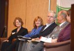 View of panelists seated.